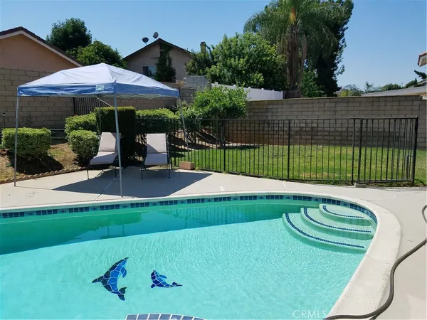 a view of a backyard with a patio and plants