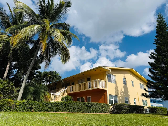 a view of a big house with a yard