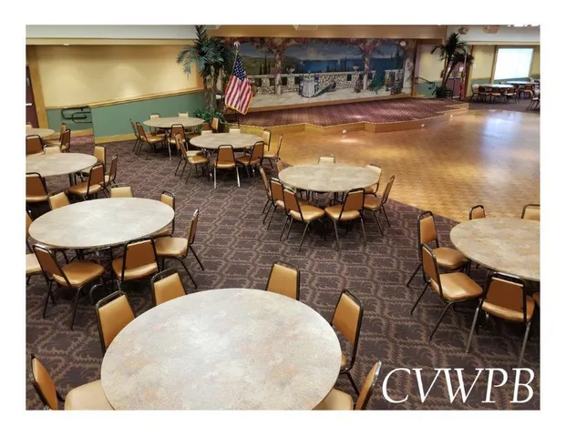 a view of a patio with dining table and chairs with wooden floor