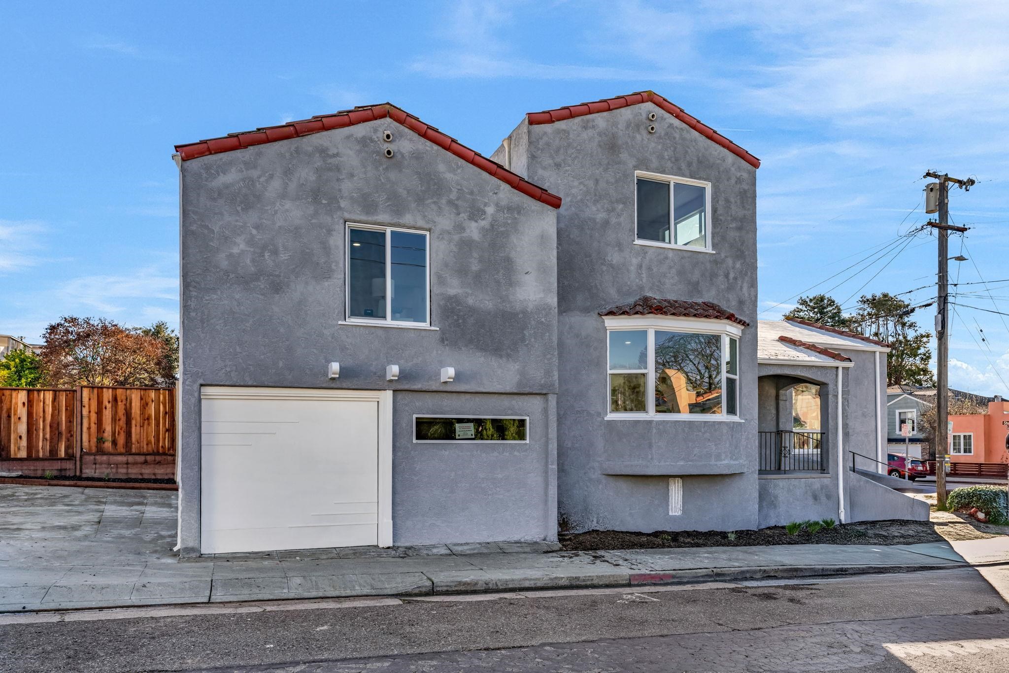 1482 Lincoln Street Berkeley, CA 94702 - Photo 2 of 49 a front view of a house with a yard and garage
