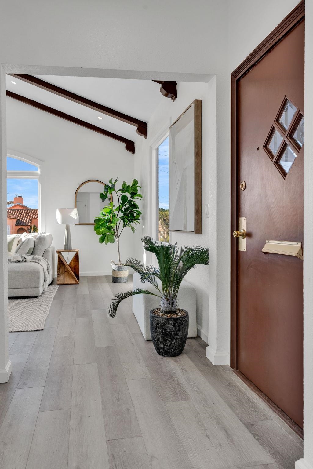 1482 Lincoln Street Berkeley, CA 94702 - Photo 7 of 49 a living room with furniture a potted plant and a large mirror