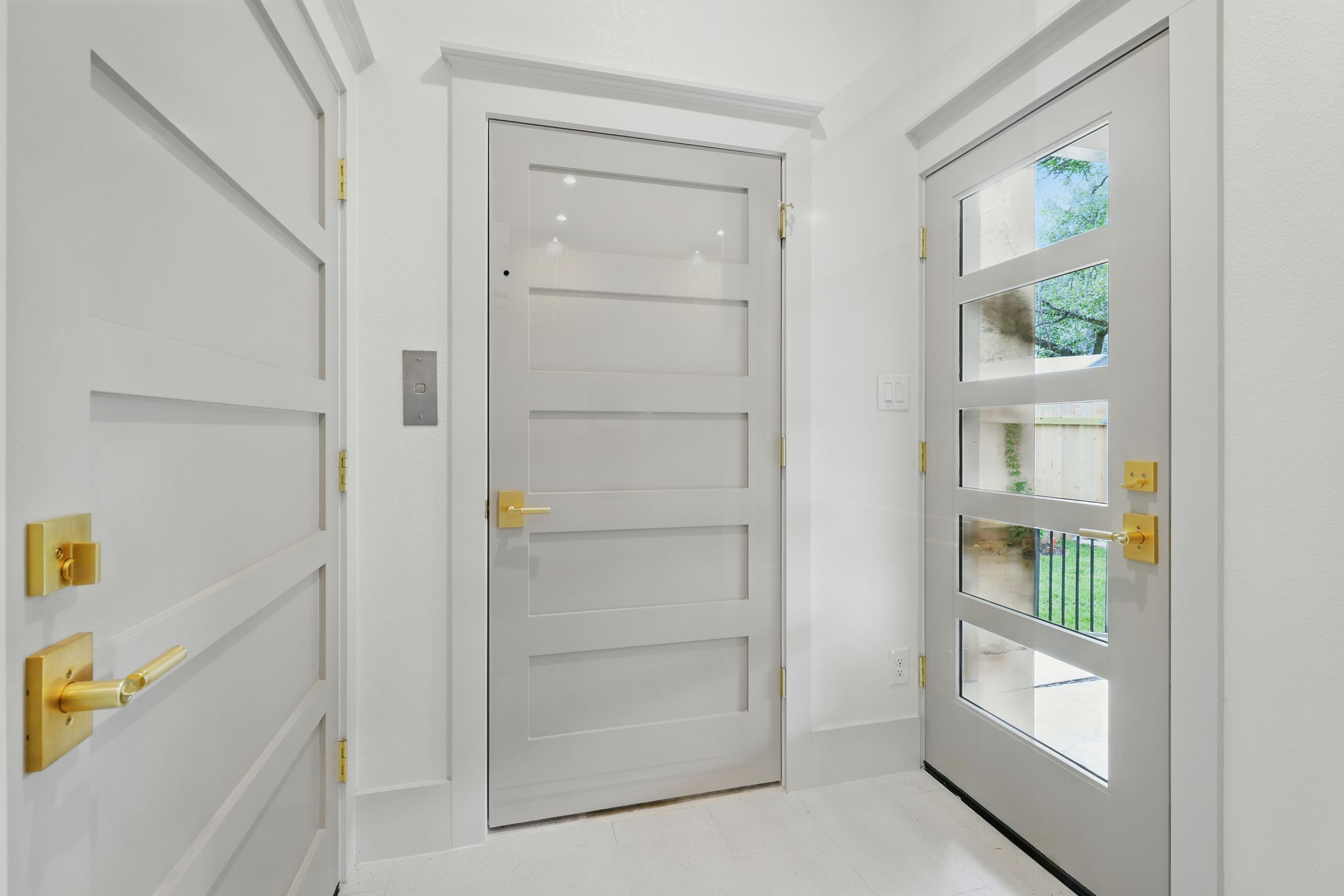 6905 Rudi Cove Austin, TX 78759 - Photo 29 of 37 Three contemporary doors with stylish gold hardware provide an elegant entry point.