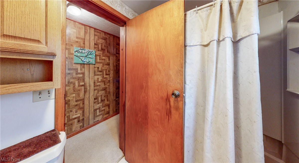 466 Pine Lake Road Sebring, OH 44672 - Photo 30 of 30 Bathroom featuring toilet and wood walls