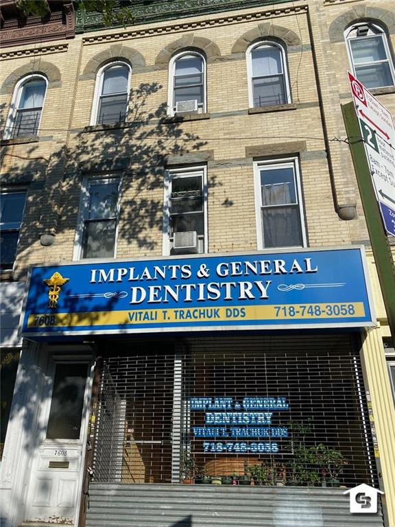 a view of building with door and balcony