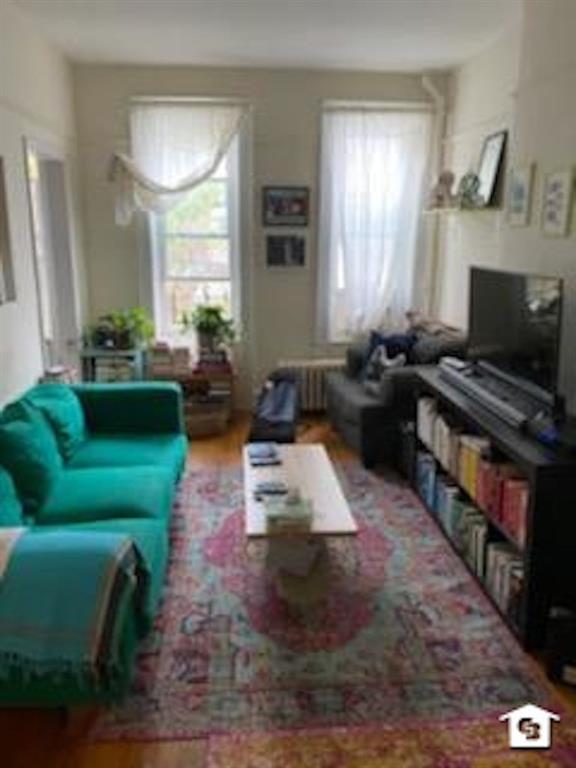 7608 3rd Avenue Brooklyn, NY 11209 - Photo 2 of 12 a living room with furniture and a fireplace