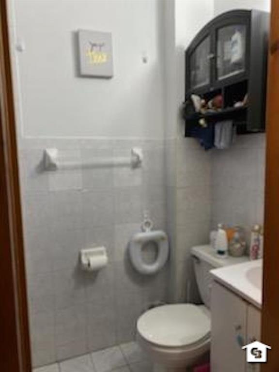 7608 3rd Avenue Brooklyn, NY 11209 - Photo 11 of 12 a bathroom with a toilet and a sink
