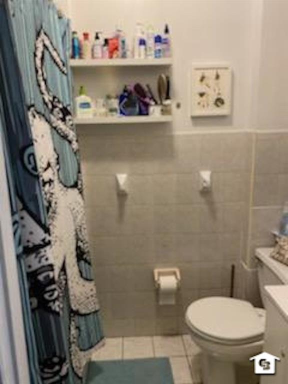 7608 3rd Avenue Brooklyn, NY 11209 - Photo 12 of 12 a bathroom with a toilet and a shower curtain