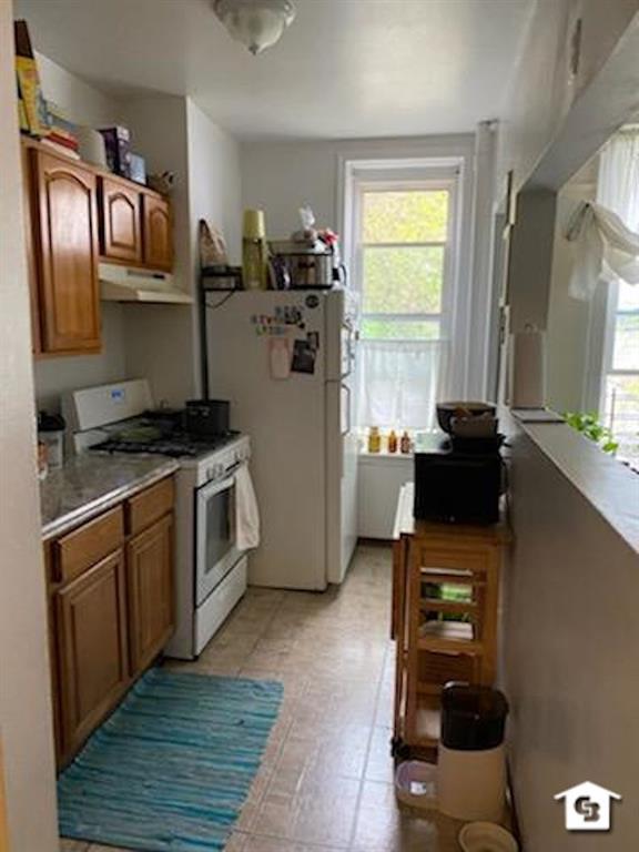 7608 3rd Avenue Brooklyn, NY 11209 - Photo 3 of 12 a kitchen with stainless steel appliances a stove sink and wooden floor