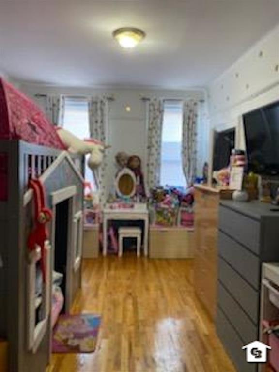 7608 3rd Avenue Brooklyn, NY 11209 - Photo 9 of 12 a living room with furniture and a flat screen tv