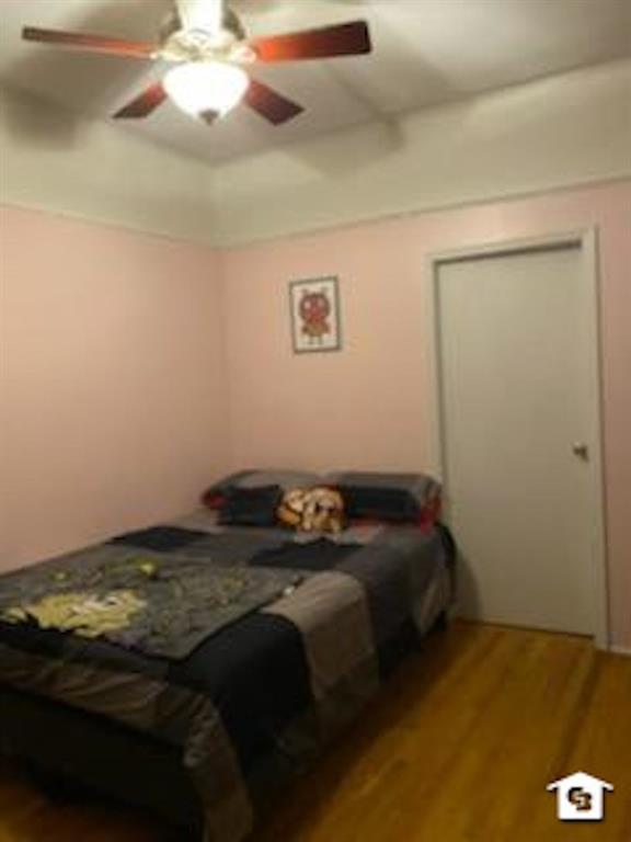 7608 3rd Avenue Brooklyn, NY 11209 - Photo 10 of 12 a bed sitting in a bedroom next to a window