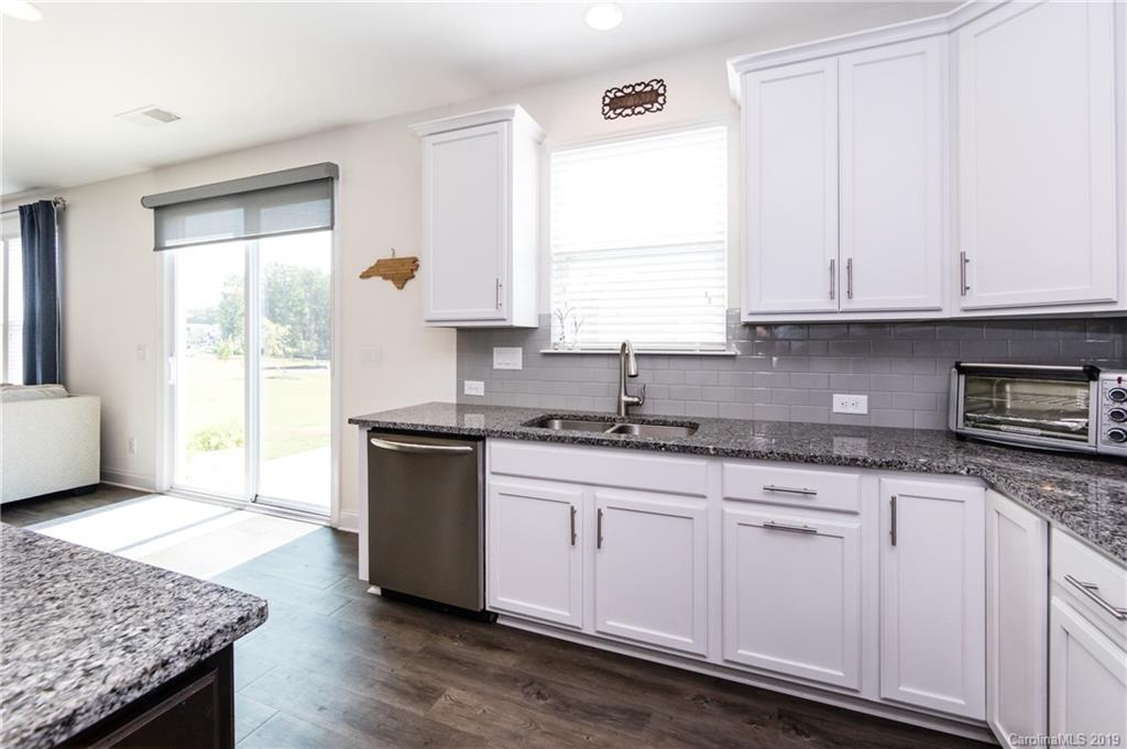 213 Morgan's Branch Road Belmont, NC 28012 - Photo 14 of 41 a kitchen with granite countertop wooden cabinets and a sink