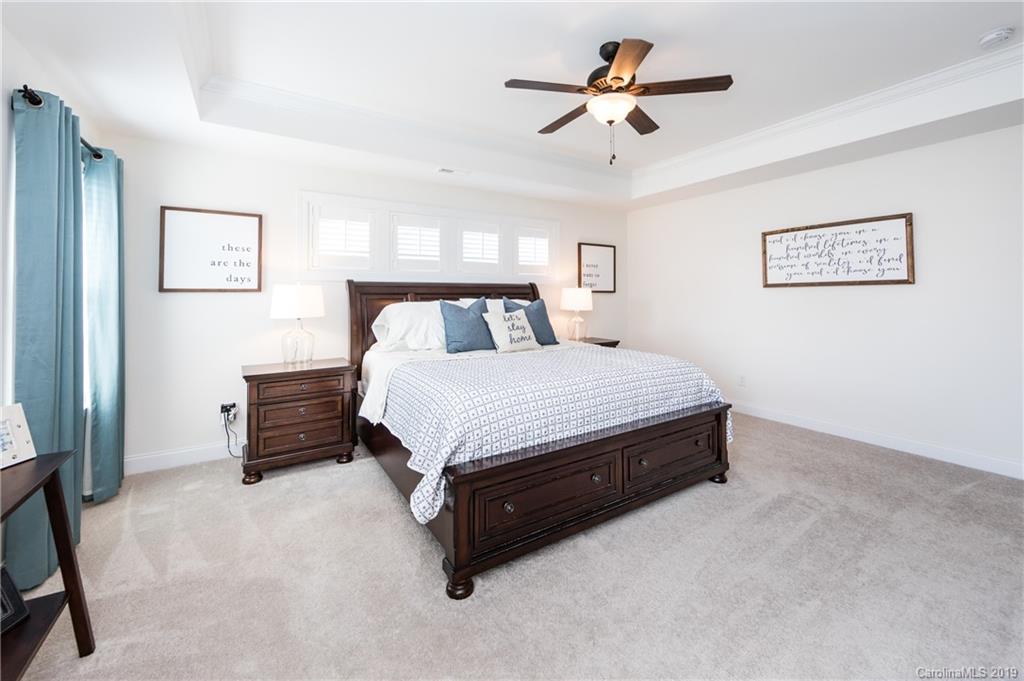 213 Morgan's Branch Road Belmont, NC 28012 - Photo 23 of 41 a bedroom with a bed and a chandelier