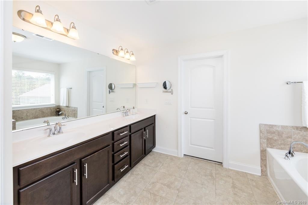 213 Morgan's Branch Road Belmont, NC 28012 - Photo 24 of 41 a spacious bathroom with a double vanity sink a mirror and a bathtub