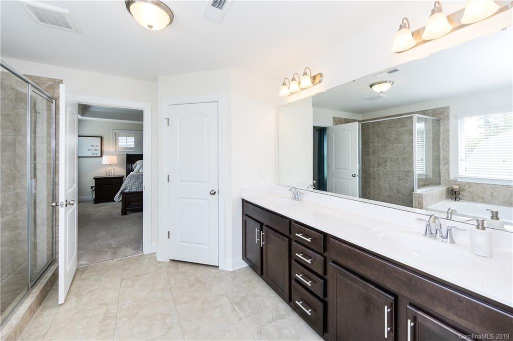 213 Morgan's Branch Road Belmont, NC 28012 - Photo 26 of 41 a spacious bathroom with a double vanity sink a and a mirror
