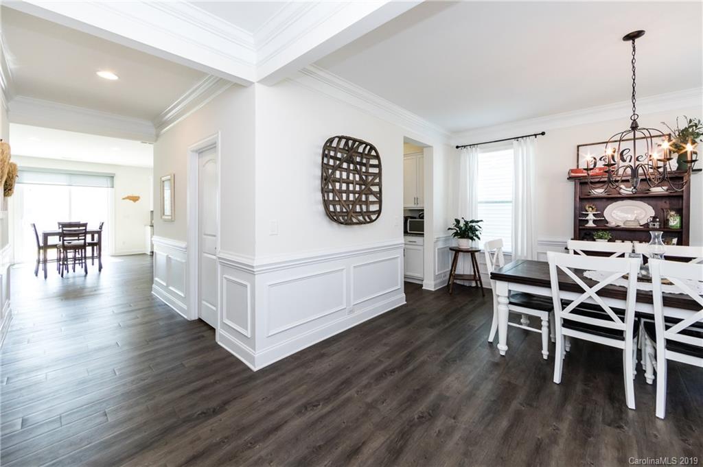 213 Morgan's Branch Road Belmont, NC 28012 - Photo 6 of 41 a dining room with furniture wooden floor a rug a potted plant and a chandelier