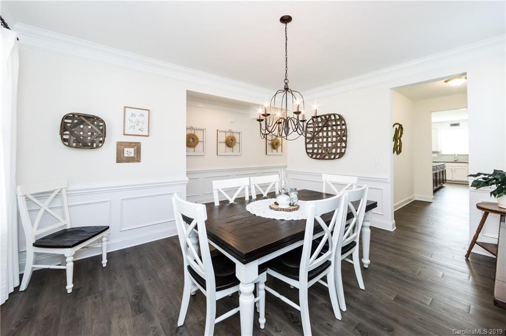 213 Morgan's Branch Road Belmont, NC 28012 - Photo 8 of 41 a view of a dining room with furniture wooden floor and chandelier