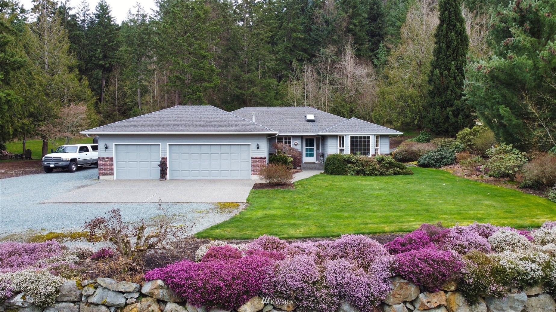18849 Cascade Ridge Court Mount Vernon, WA 98274 - Photo 1 of 38 a front view of a house with a yard and a garden
