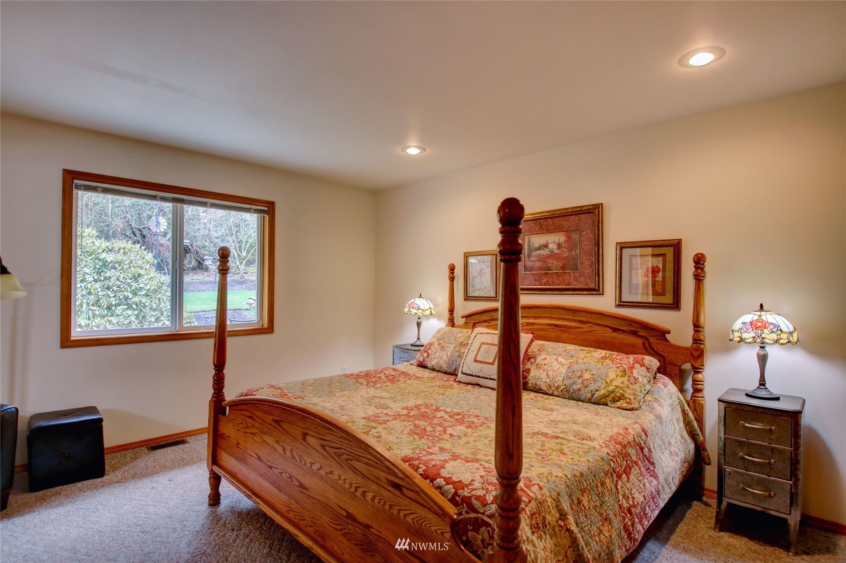 18849 Cascade Ridge Court Mount Vernon, WA 98274 - Photo 15 of 38 a bedroom with a bed and a chandelier