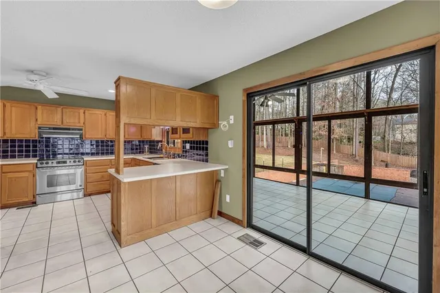 a kitchen with stainless steel appliances a large counter top and a stove