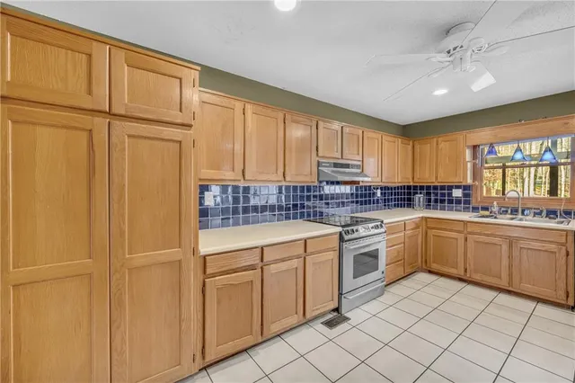 a kitchen with cabinets and window