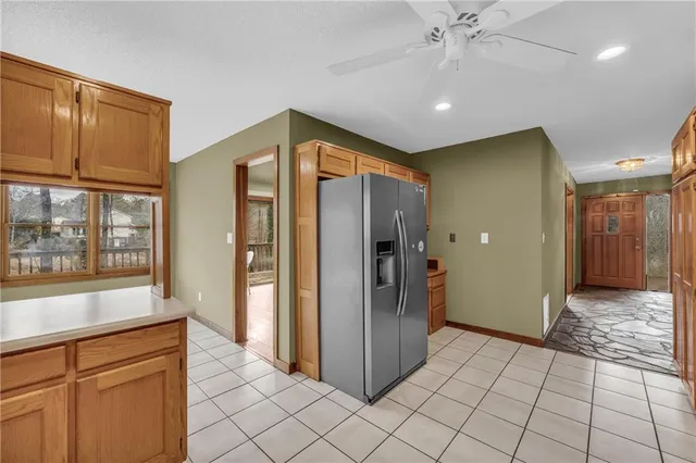 a view of a hallway with wooden floor and a kitchen