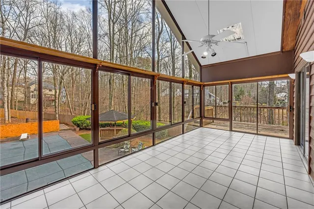 a spacious bedroom with a bed and a chandelier