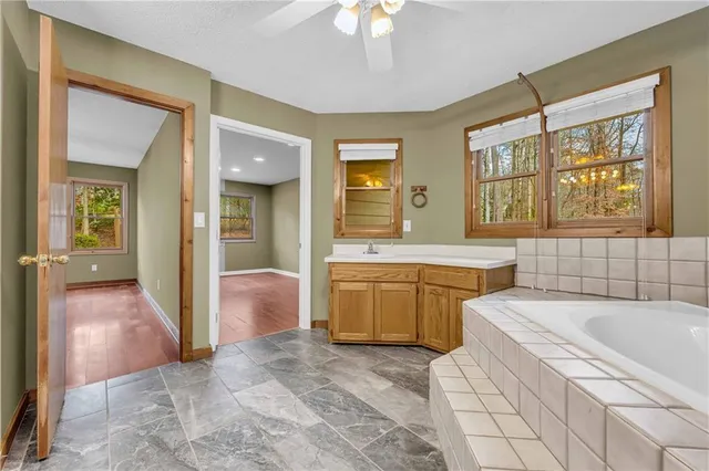 a view of a livingroom with a ceiling fan and window