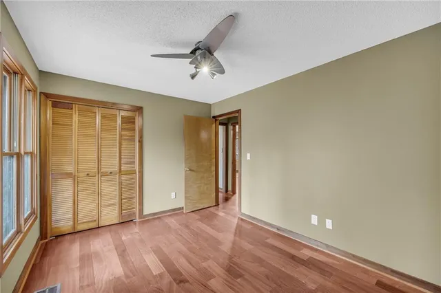 a view of an empty room with a fireplace and a window