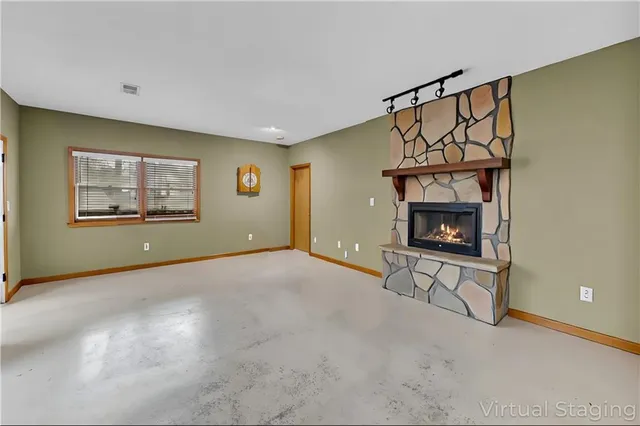 a living room with furniture a fireplace and a table