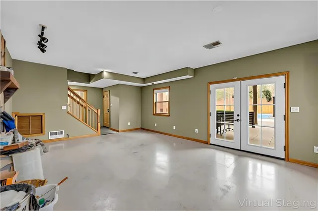 en empty room with windows and fan