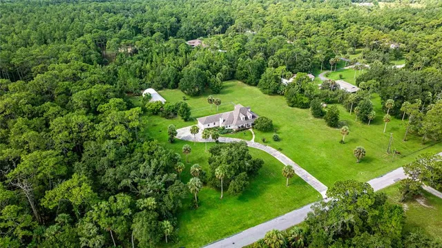 a kitchen with stainless steel appliances a sink a stove top oven a counter space and cabinets