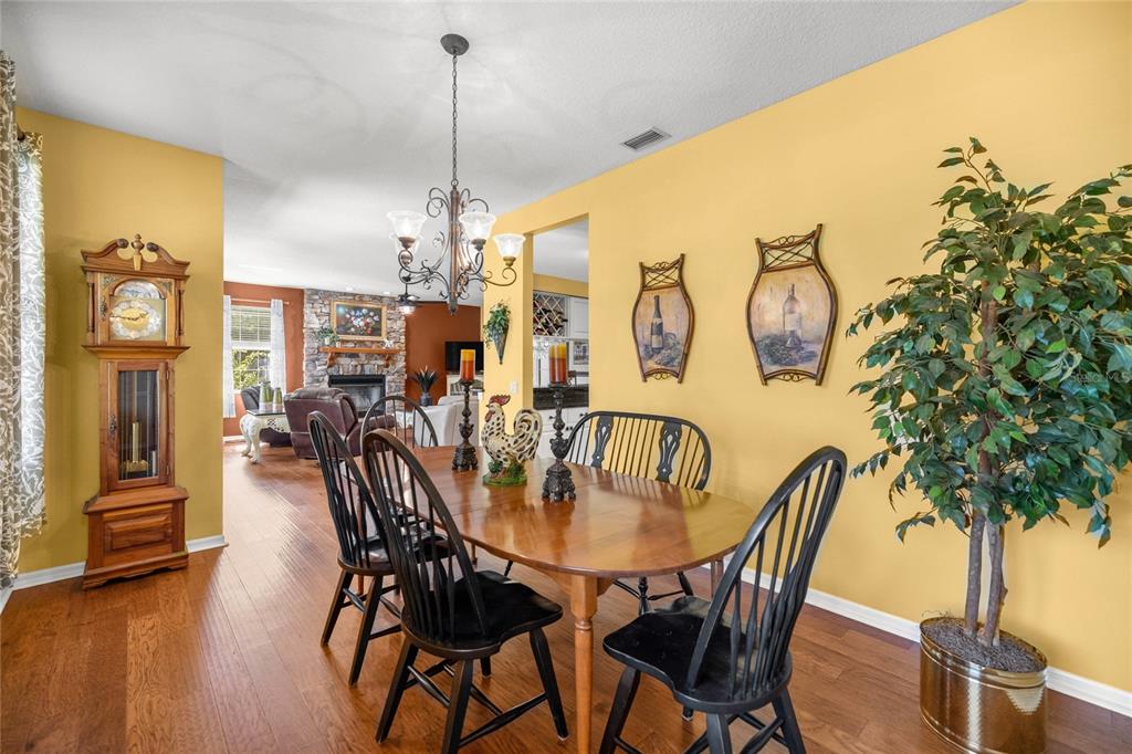 10264 West Springtree Lane Crystal River, FL 34428 - Photo 13 of 87 a dining room with furniture and wooden floor