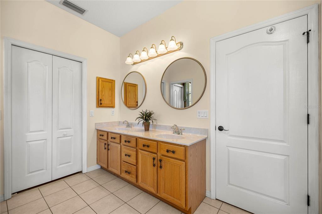 10264 West Springtree Lane Crystal River, FL 34428 - Photo 37 of 87 a bathroom with a double vanity sink and a mirror
