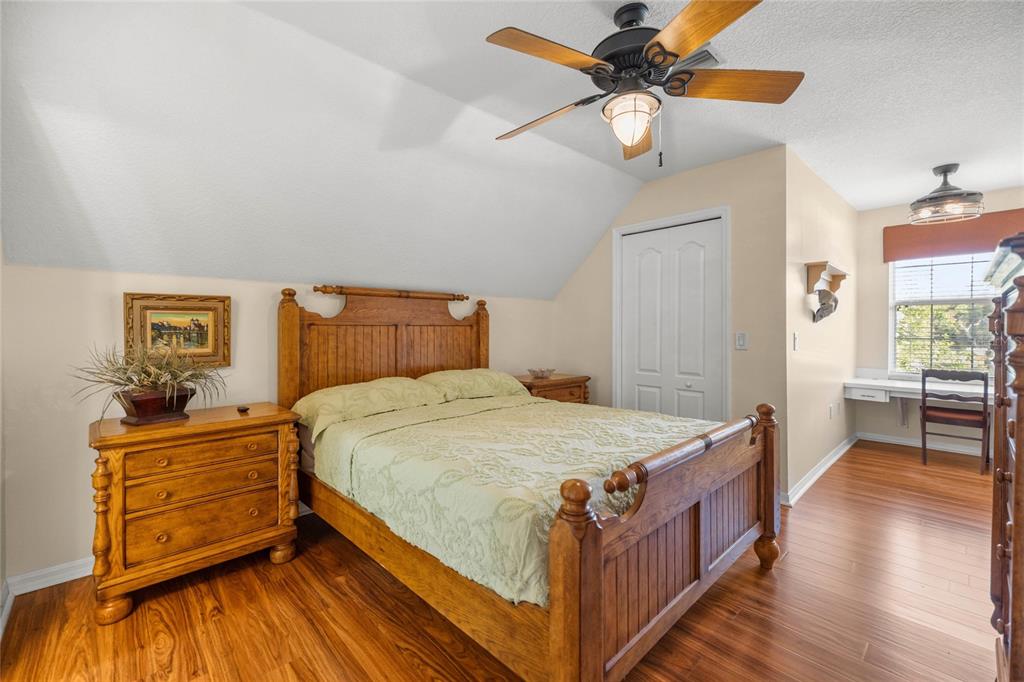 10264 West Springtree Lane Crystal River, FL 34428 - Photo 44 of 87 a bedroom with a bed and a chandelier