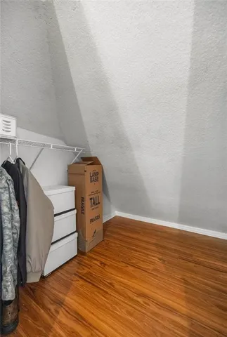 a view of a house with a big yard plants and large trees