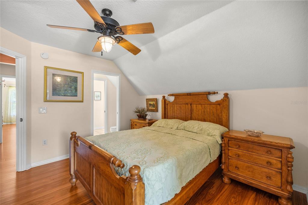 10264 West Springtree Lane Crystal River, FL 34428 - Photo 47 of 87 a bedroom with a bed and a chandelier