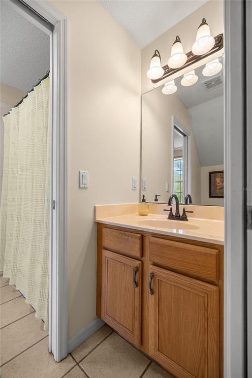 10264 West Springtree Lane Crystal River, FL 34428 - Photo 51 of 87 a bathroom with a double vanity sink and a mirror