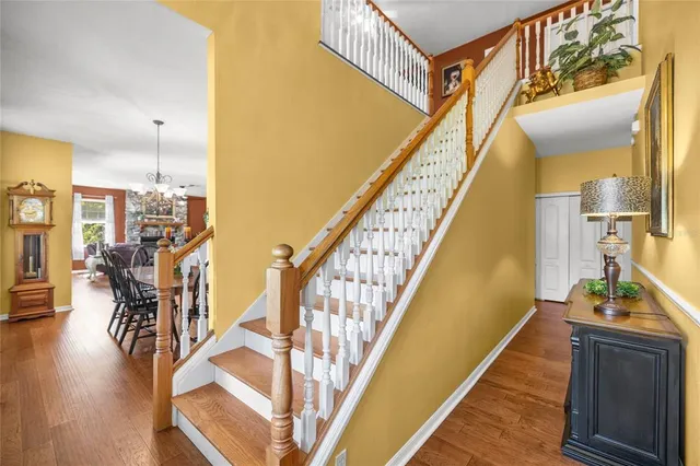 a view of a hallway with wooden floor and entryway
