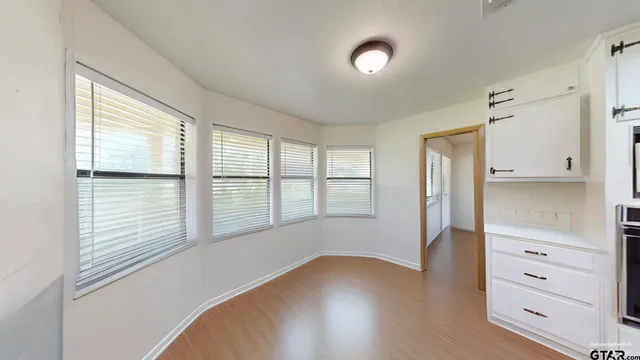 a kitchen with a stove cabinets and wooden floor