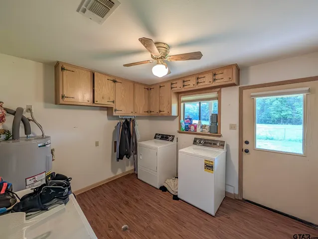 a view of washer and dryer with kitchen view