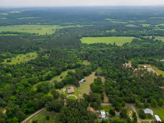 an aerial view of a golf course with a lake view