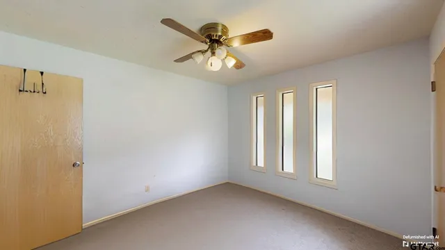 a bedroom with a bed and ceiling fan