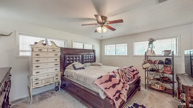 a bed room with a bed and a chandelier