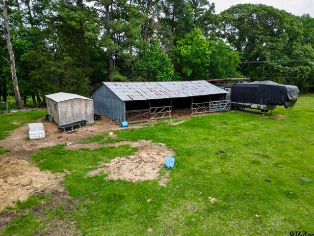 a view of a swimming pool with a garden and trees