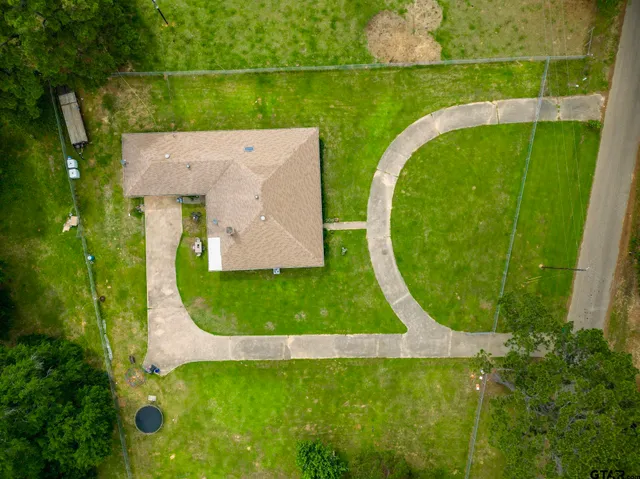 an aerial view of a house with backyard