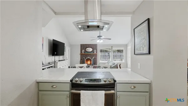 a kitchen with a sink stove and microwave