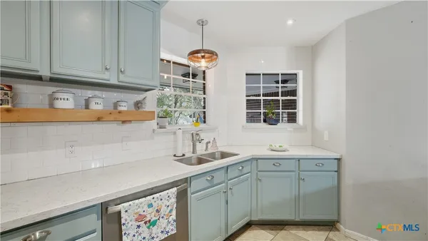 a kitchen with a sink and cabinets