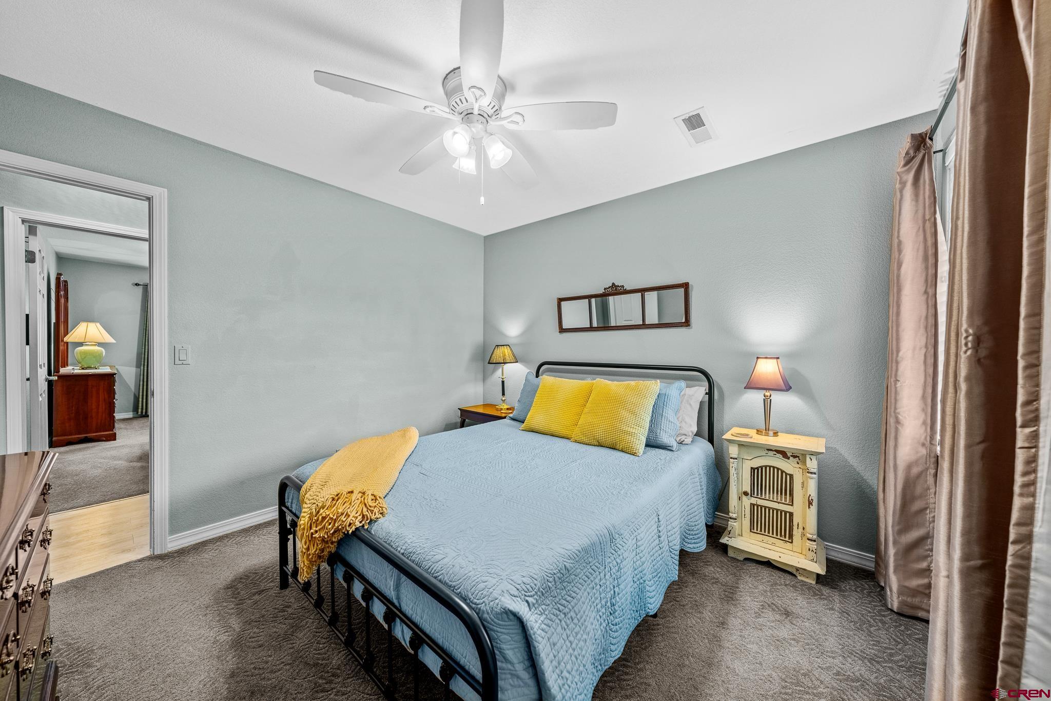780 Waterfall Lane Durango, CO 81301 - Photo 19 of 35 a bedroom with a bed and a chandelier