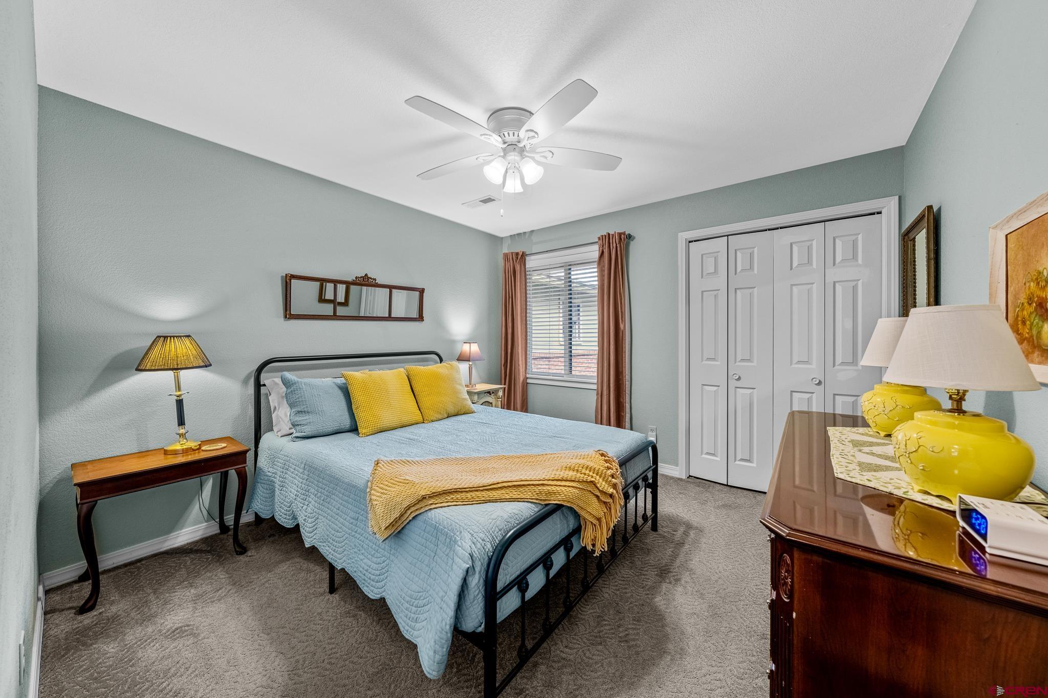 780 Waterfall Lane Durango, CO 81301 - Photo 20 of 35 a bedroom with a bed and a chandelier