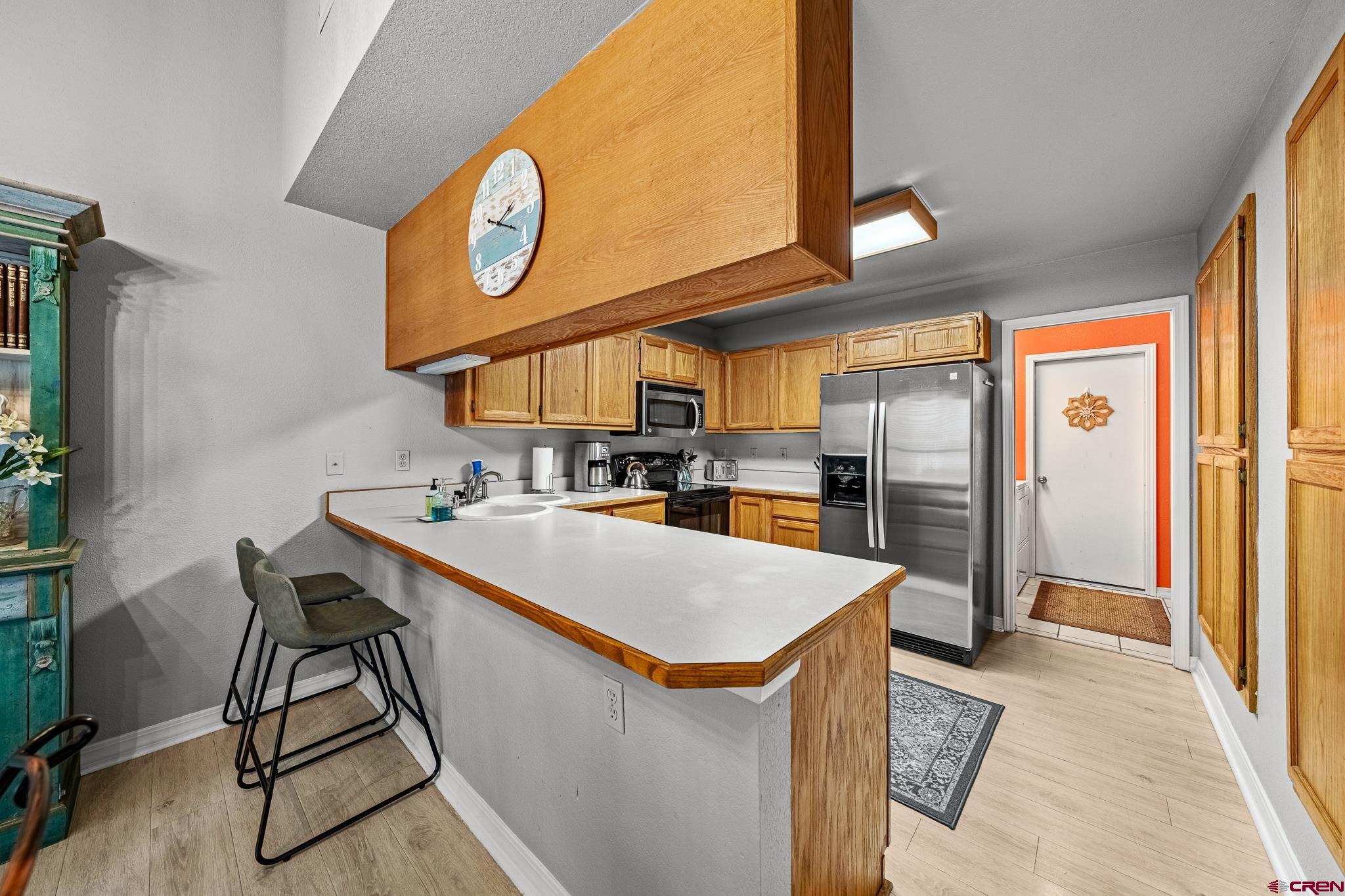 780 Waterfall Lane Durango, CO 81301 - Photo 2 of 35 a kitchen with stainless steel appliances granite countertop a sink a stove and a refrigerator